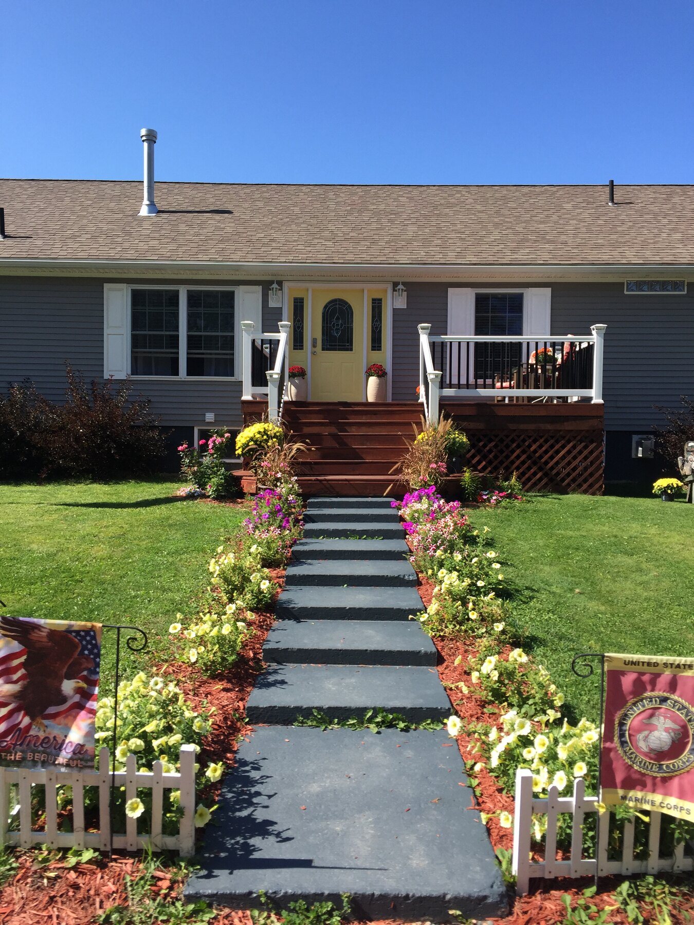 Welcoming front entry with landscaped walkway and military-family details
